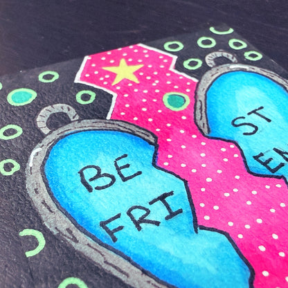 Colorful drawing of a broken heart with 'BE FRI' on a black background