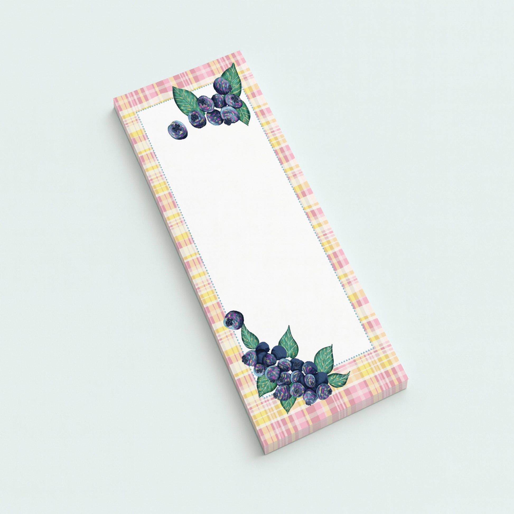 Notepad with blueberry design on a light plaid background
