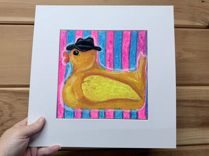 Yellow rubber duck wearing a black fedora againstpink and turquoise stripes, original oil pastel painting