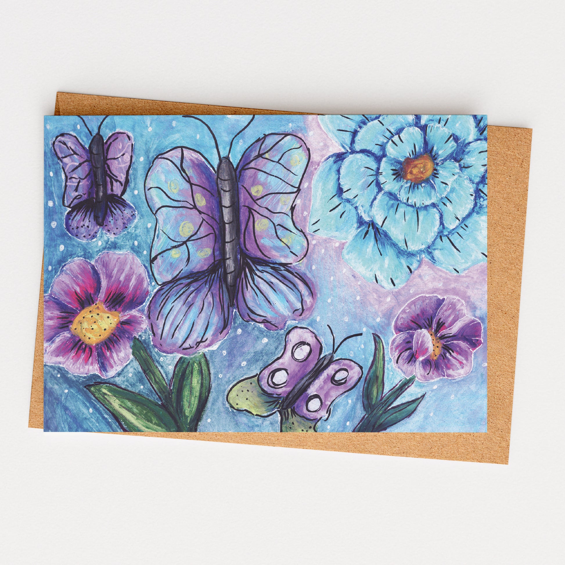 Greeting card with butterflies and flowers on a blue background