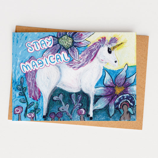 Greeting card with a unicorn and flowers, featuring the text 'Stay Magical'.