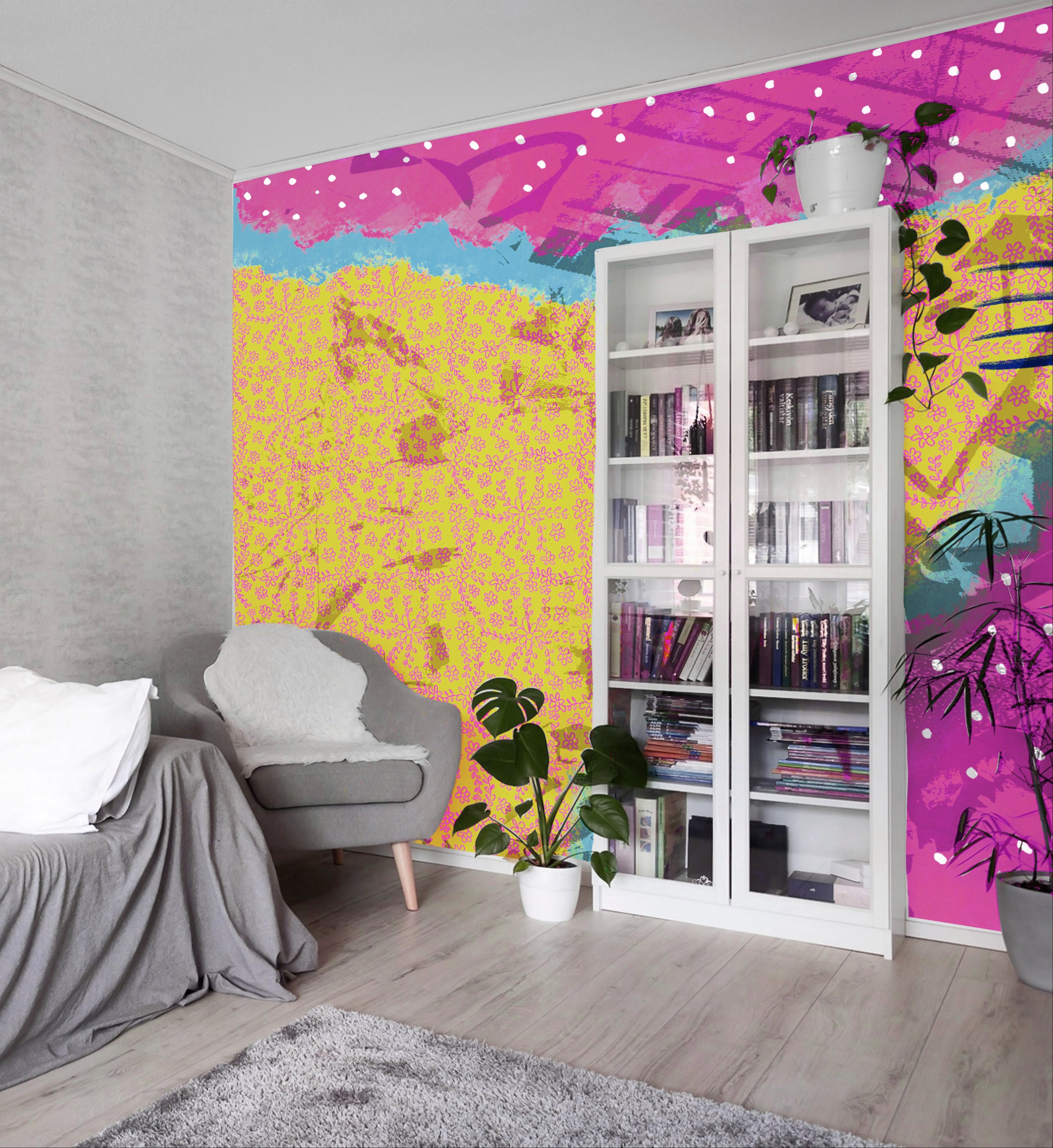 A colorful abstract wall mural featuring a bright yellow textured pattern on the left and a pink patterned section on the right, installed in a modern living room setting next to a gray sofa and a white bookshelf.